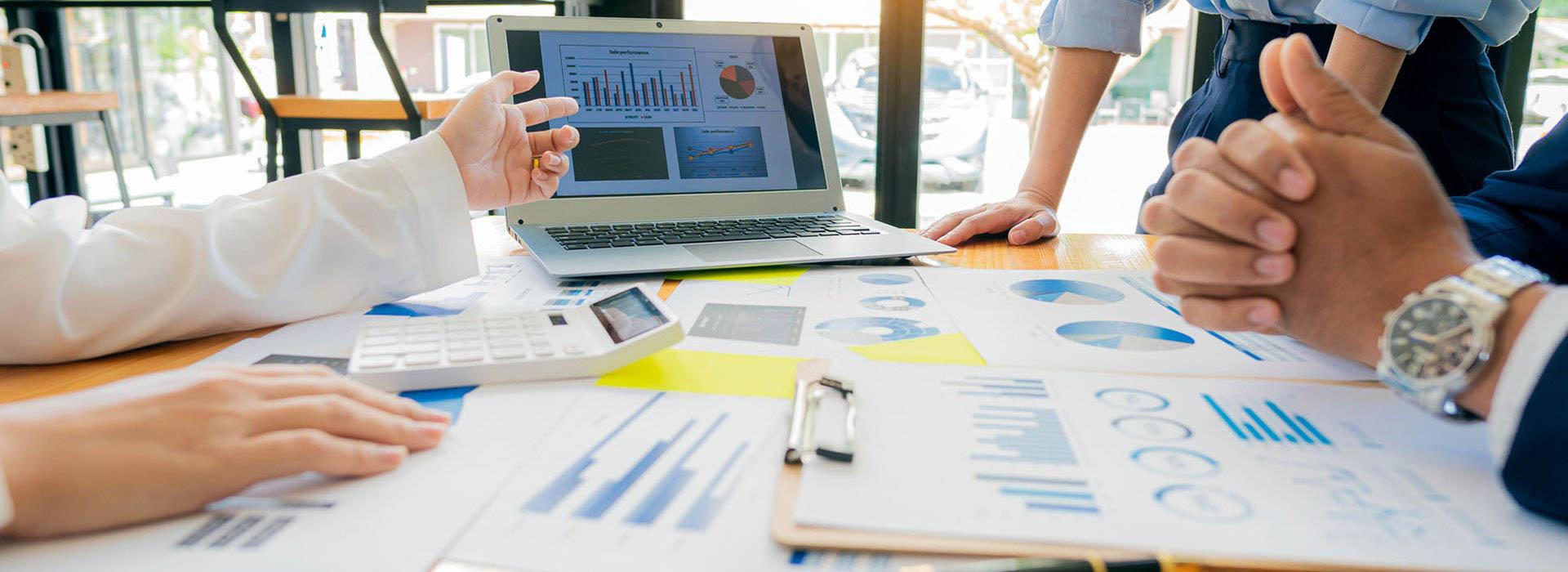 Image of computer laptop and business papers and receipts