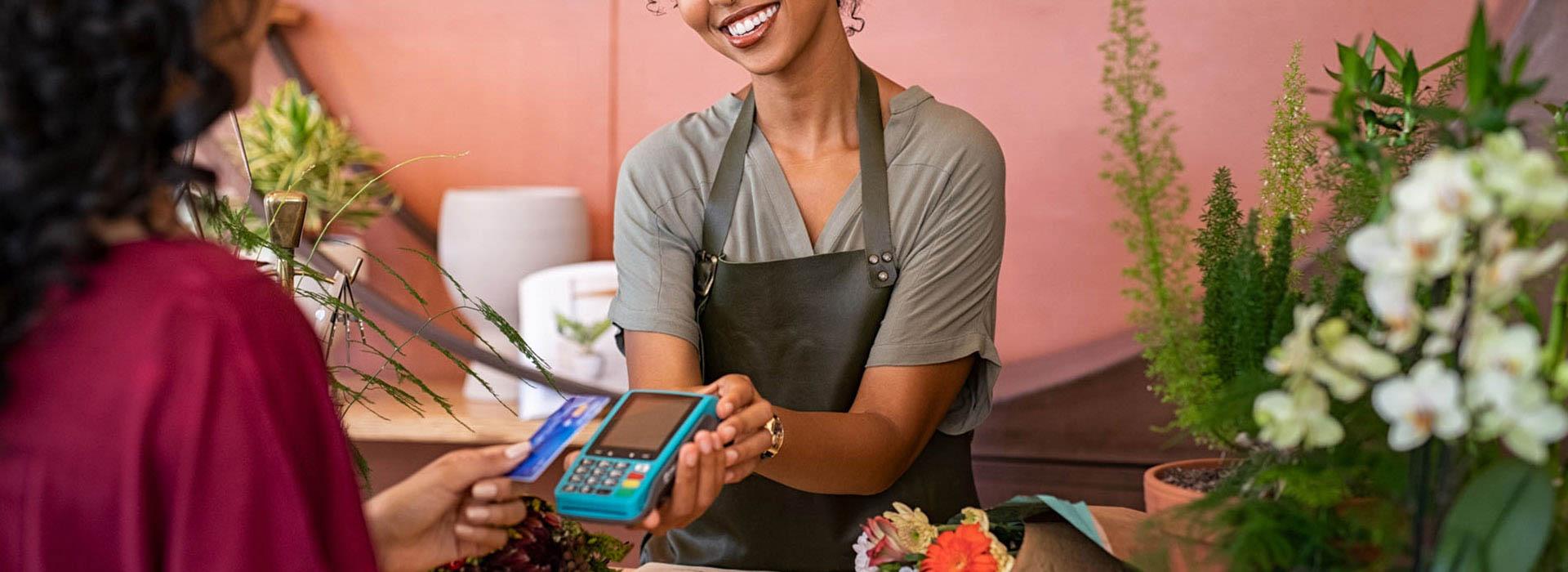 cashier handing card terminal to customer