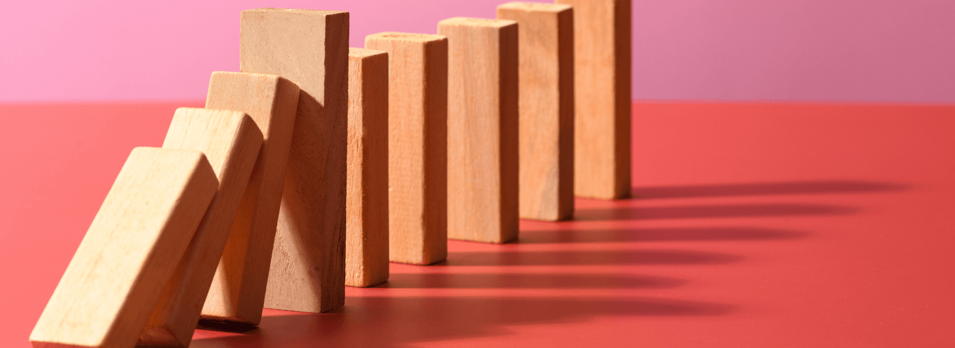 Wooden blocks against a pink background