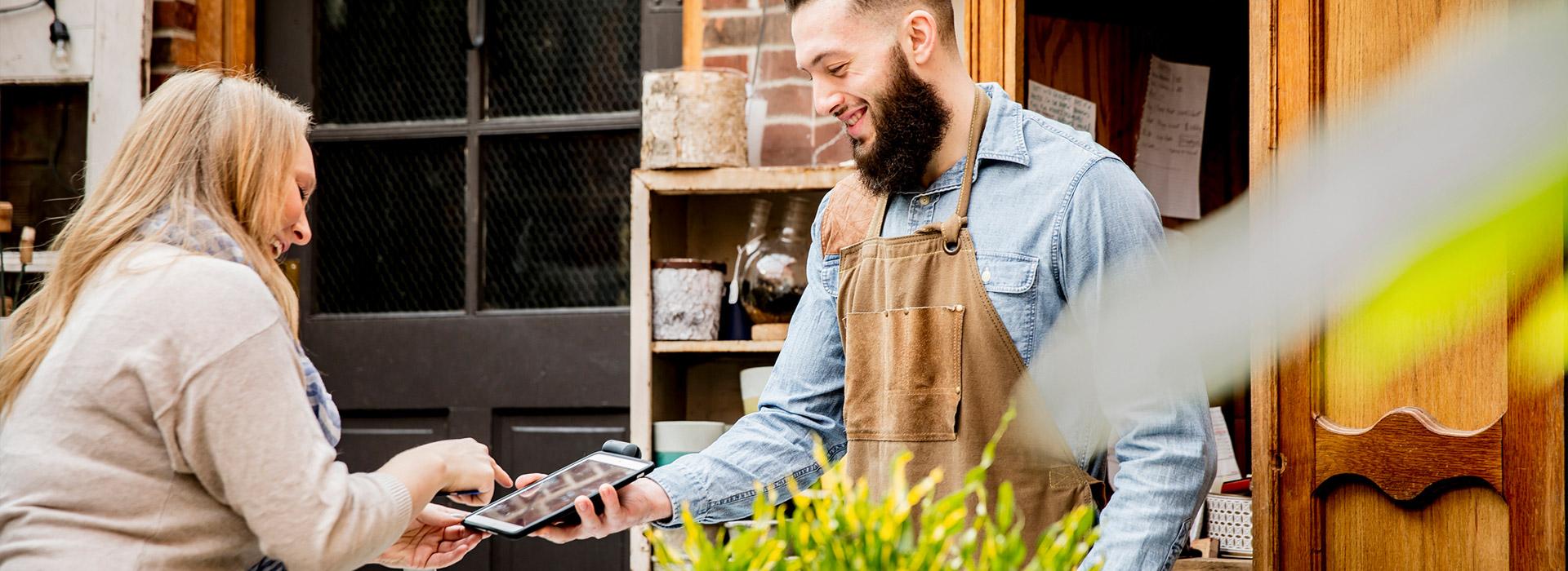 woman paying man for food