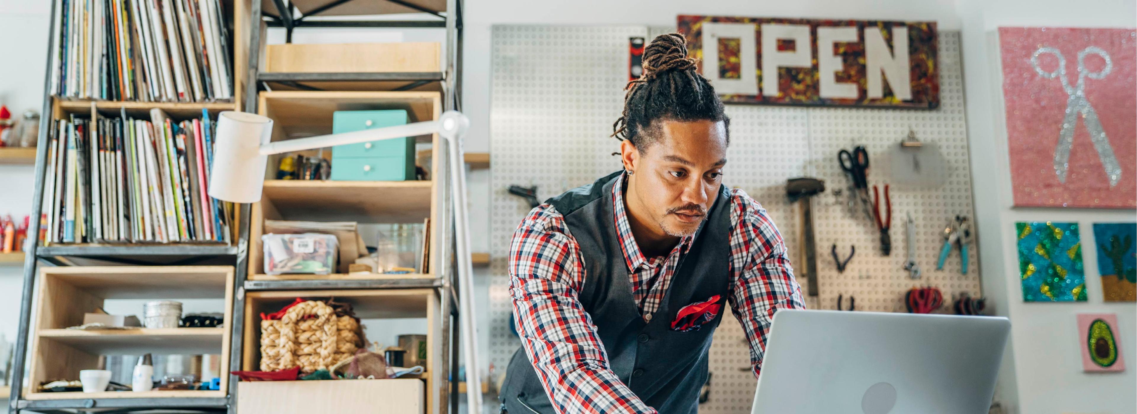 man using a laptop inside a store or office environment